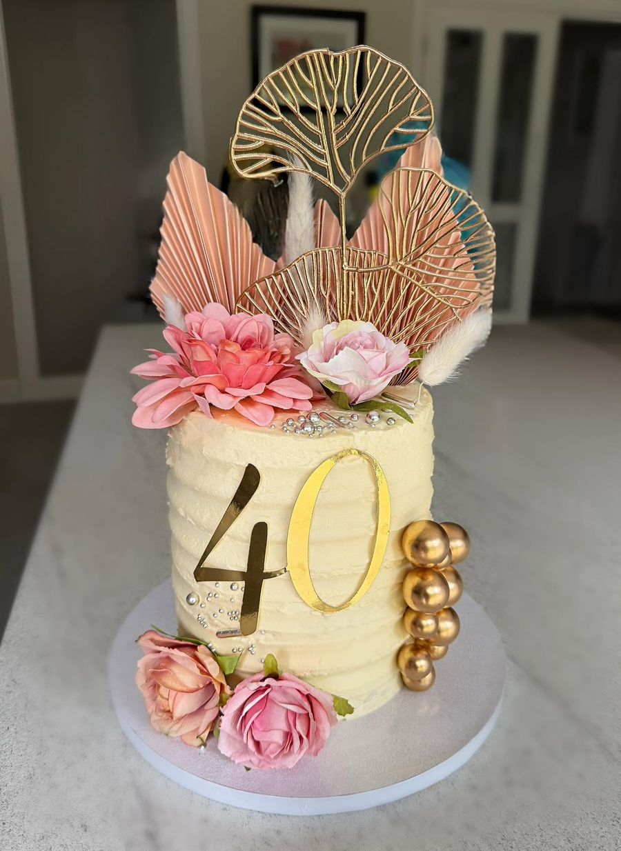 Floral 40th cake by Just In Cakes Co. Textured buttercream, blush flowers, gold number and pearls.