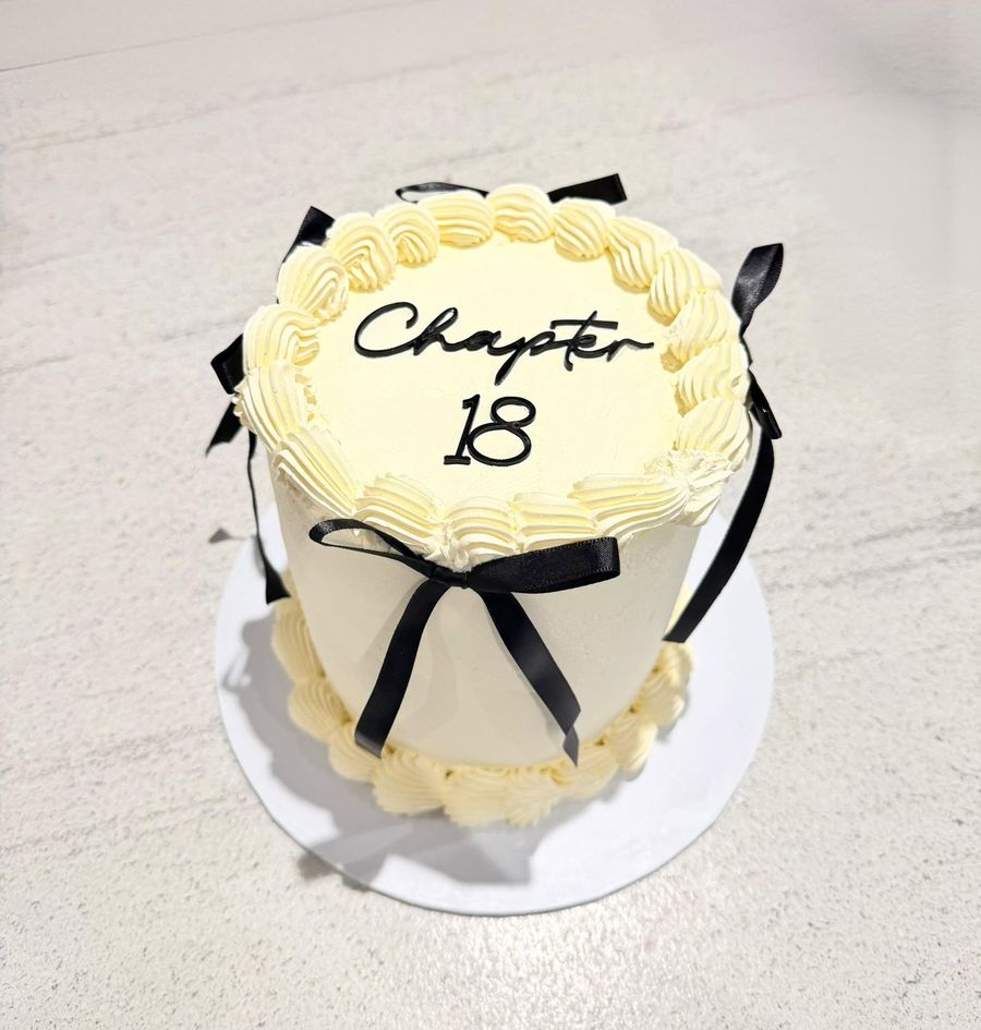 Chapter 18 cake by Just In Cakes Co. Vintage piping, black ribbon and a hand piped message.