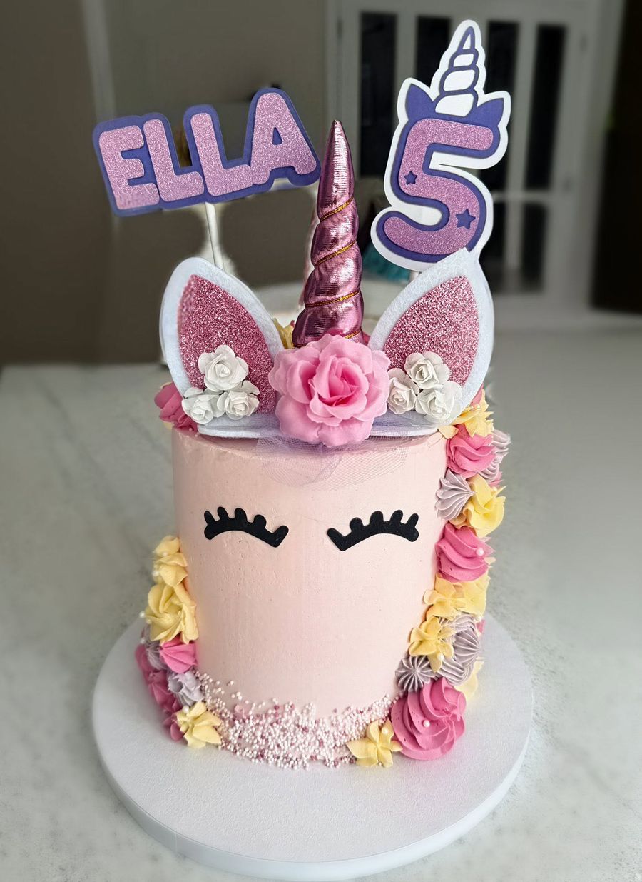 Unicorn with a name cake by Just In Cakes Co. Unicorn face, horn and ears, with piped flowers.
