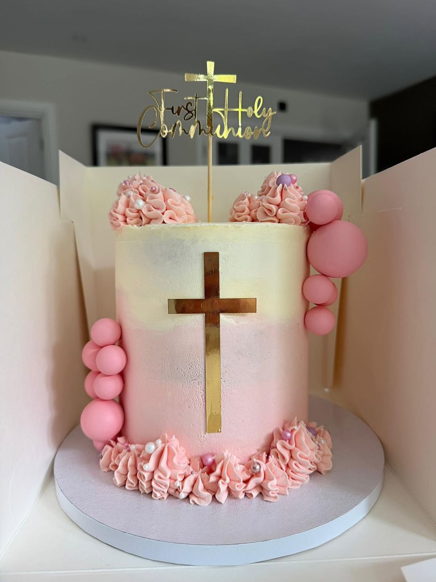 Holy Communion cake by Just In Cakes Co. Soft pink with a gold cross and pearls.