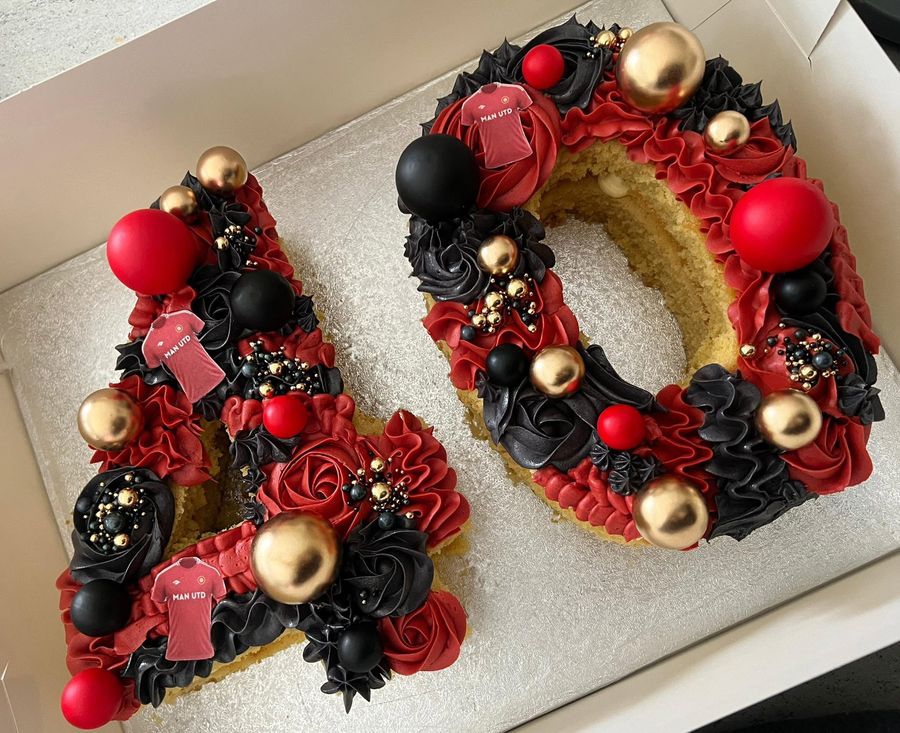 Number 40 cake by Just In Cakes Co. A number cake in red and black with gold detail.