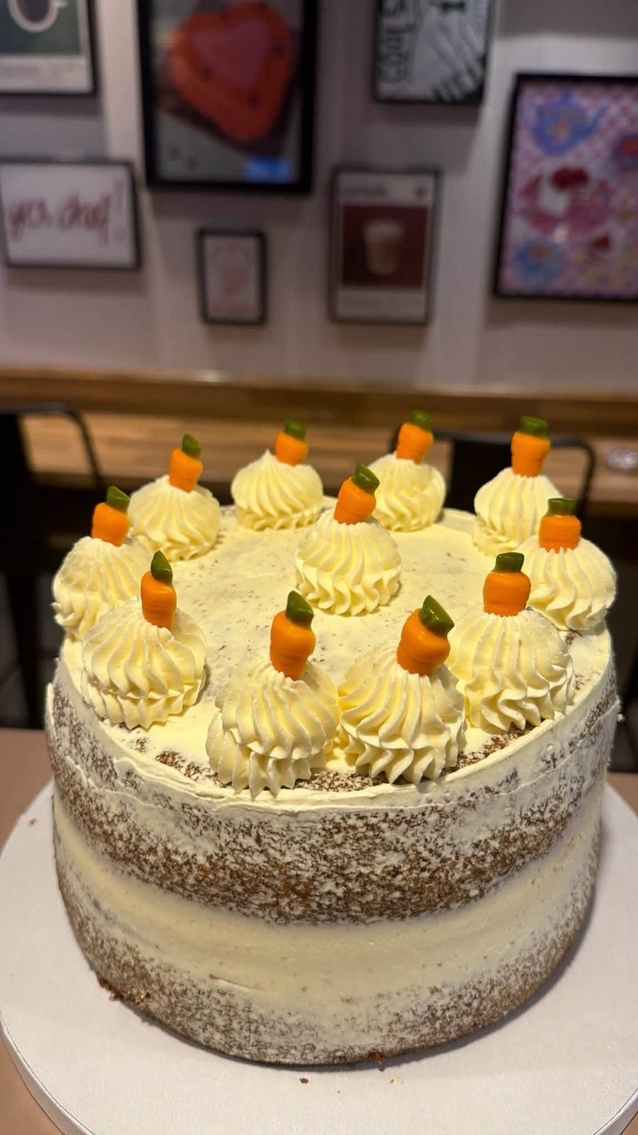 Carrot cake cake by Just In Cakes Co. Semi naked, cream cheese frosting and piped carrots.