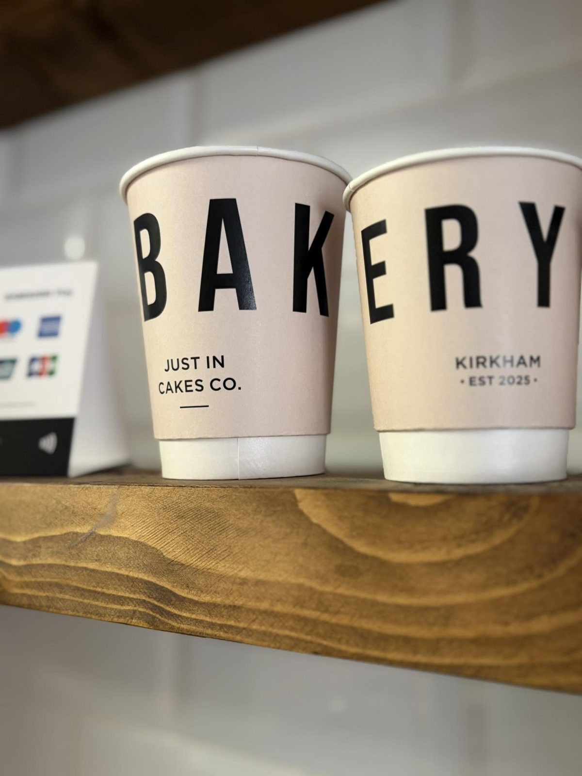 Just In Cakes Co. takeaway coffee cups on the counter