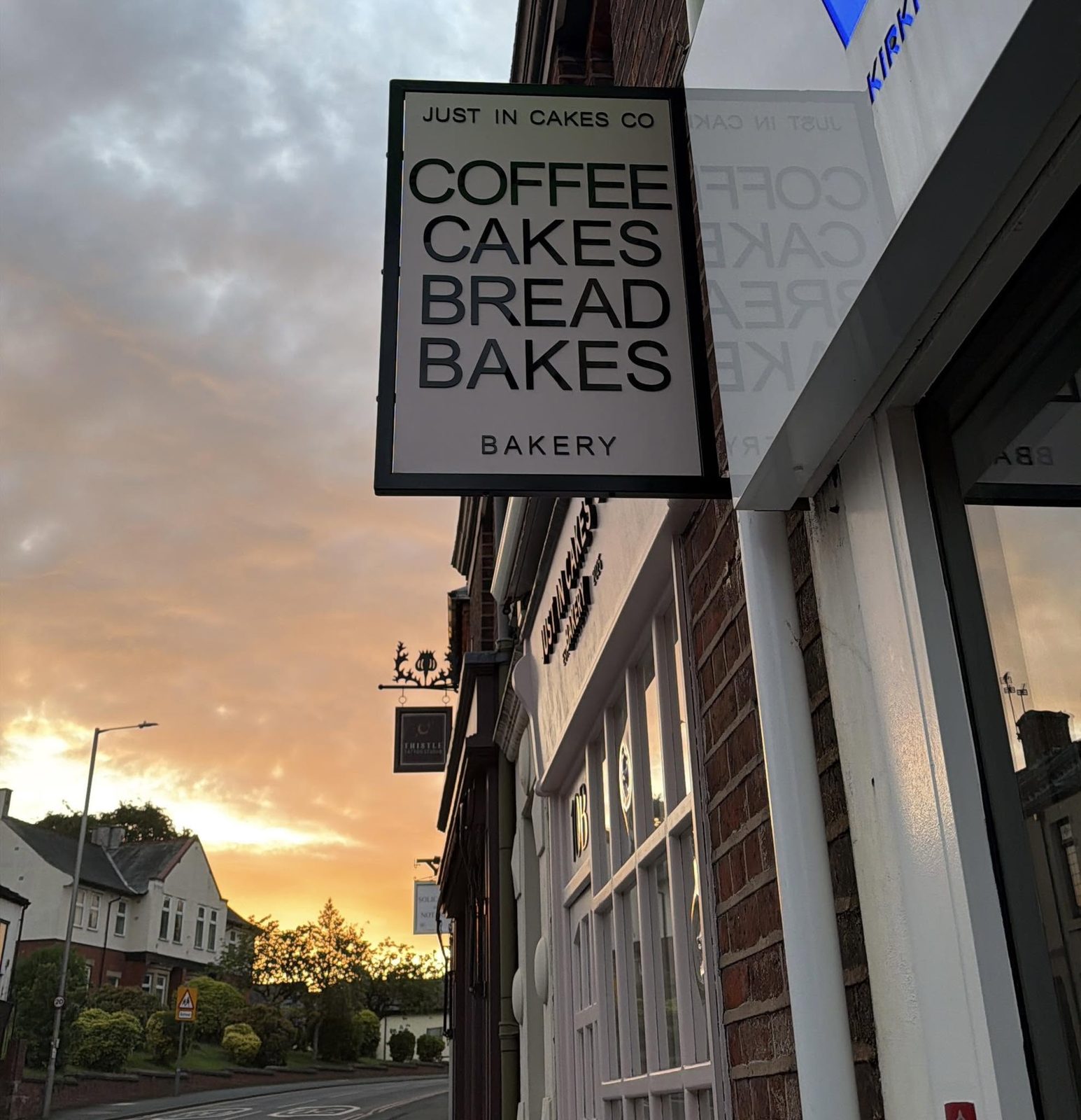 Hanging sign reading coffee, cakes, bread, bakes