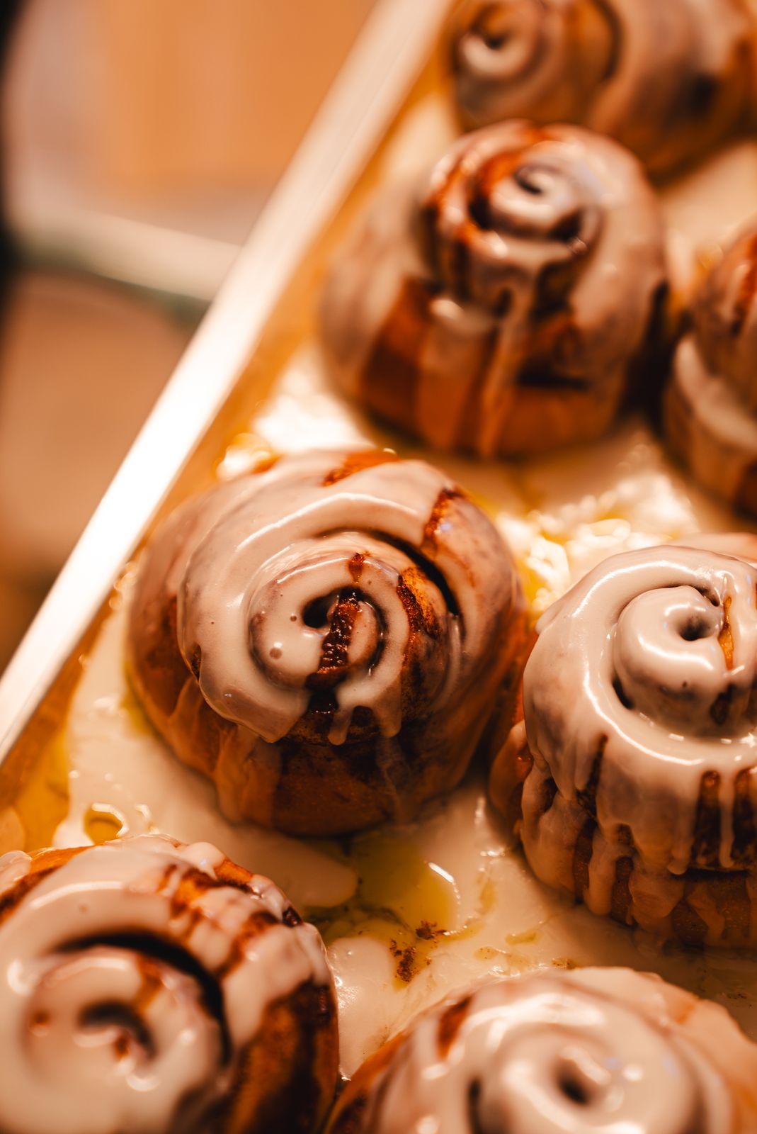A tray of iced cinnamon buns on the counter